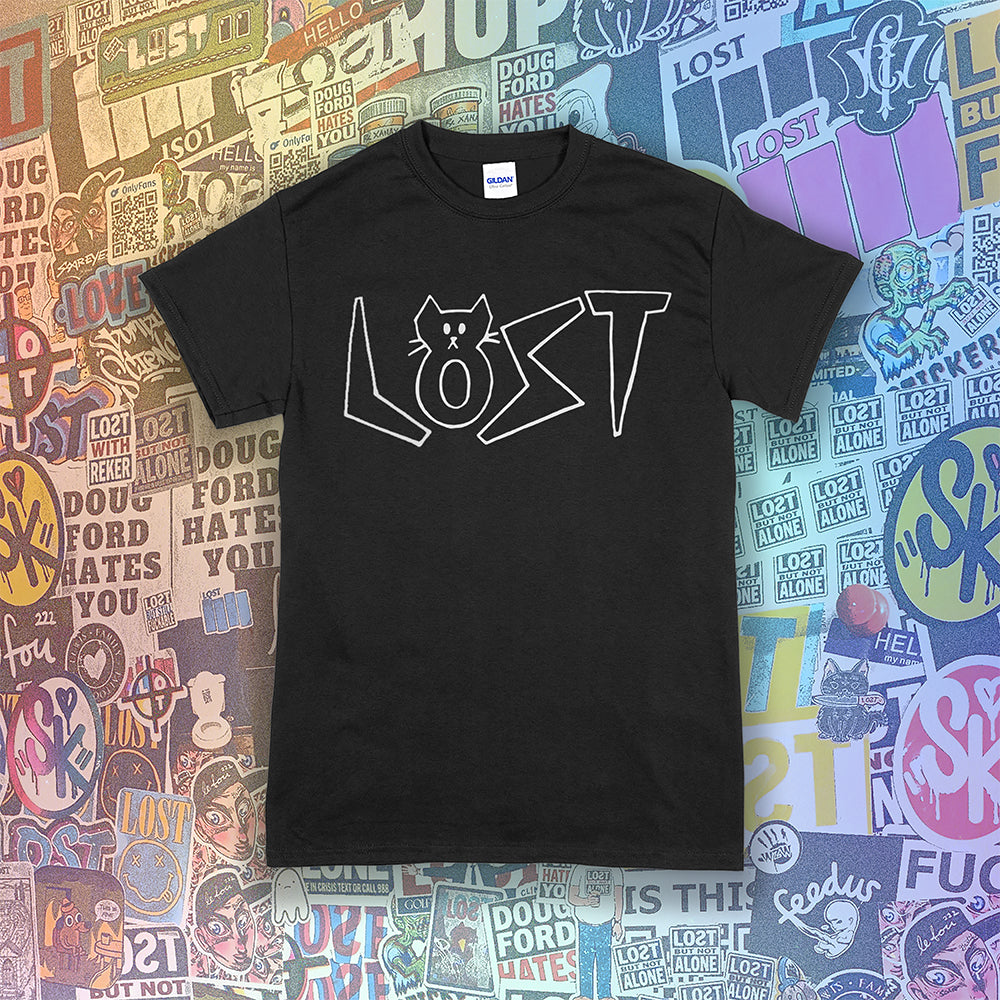 Charlottes White Cat Letters. Hand drawn design of cat shaped letters. Drawn by my daughter Charlotte, and printed with white ink on a black cotton shirt. Graffiti stickers in the background. 