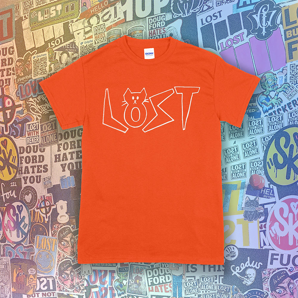 Charlottes White Cat Letters. Hand drawn design of cat shaped letters. Drawn by my daughter Charlotte, and printed with white ink on an orange cotton shirt. Graffiti stickers in the background. 