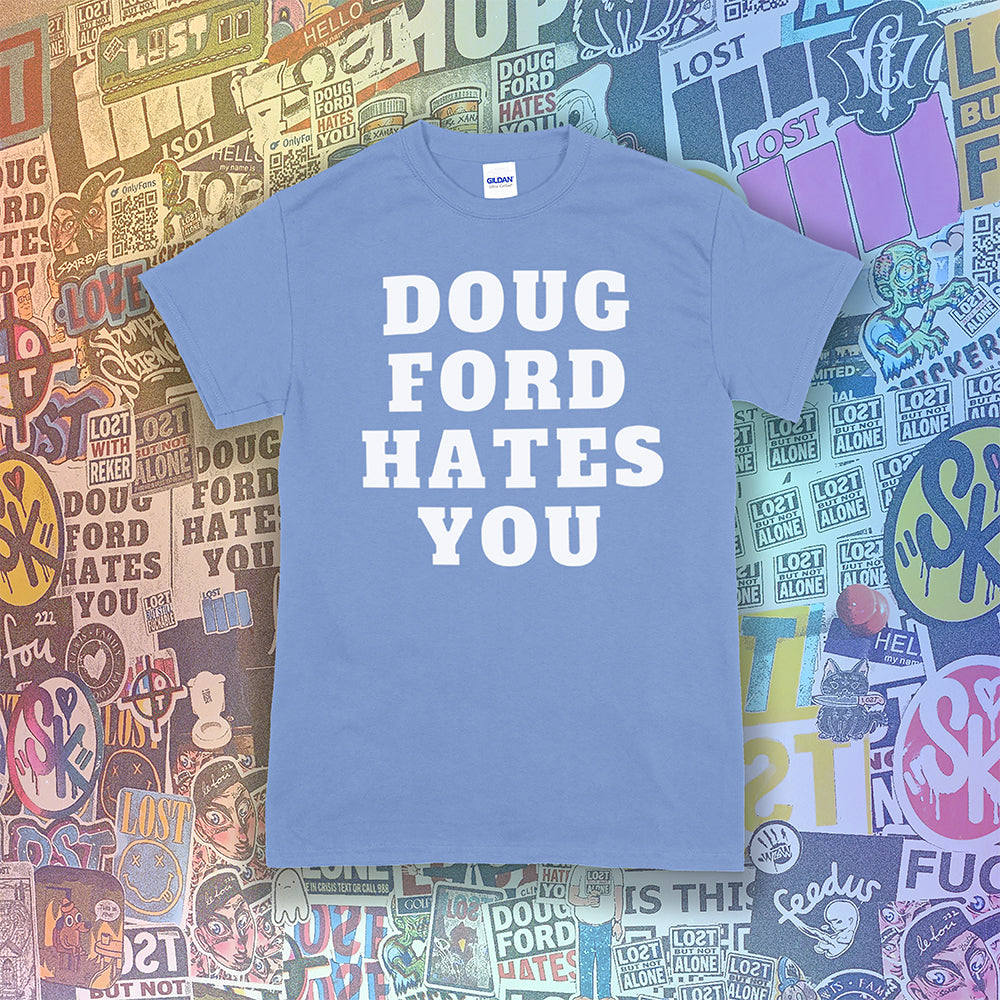 The original Doug Ford Hates You t-shirt. Bold white letters screen printed on a light blue shirt. Colorful graffiti stickers make up the background.