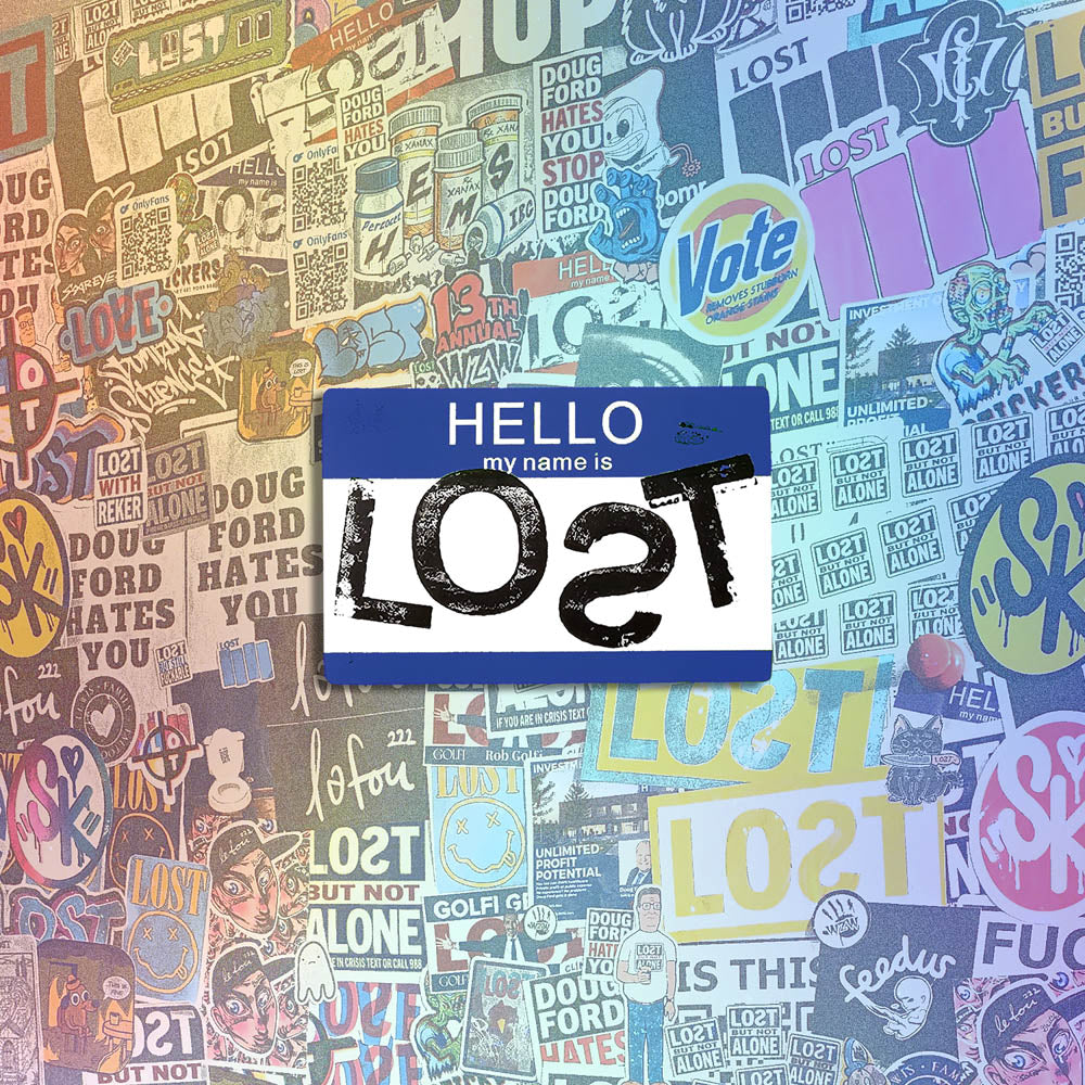 Hello my name is LOST sticker. A blue and white nametag sticker stamped with the name LOST with a backwards S. The sticker is set against a wall of stickers from international graffiti artists.