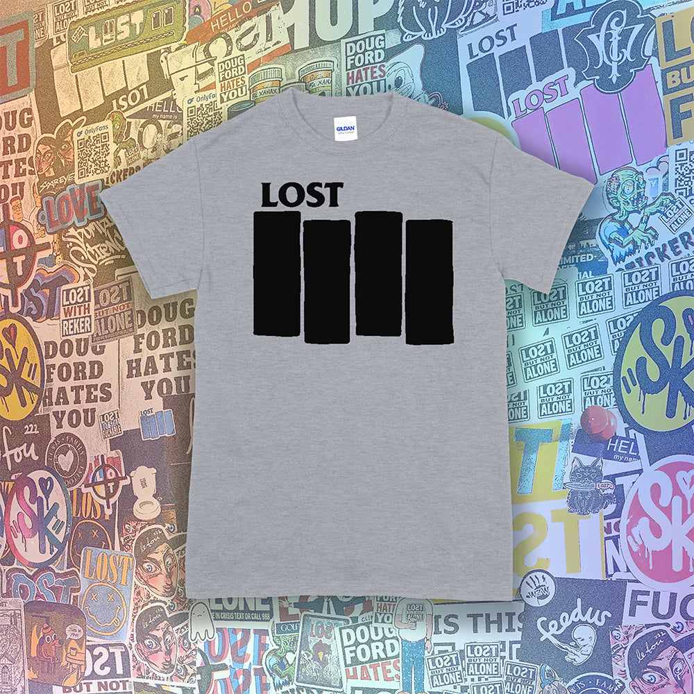 The Lost Flag t-shirt. A bold and iconic Black logo screen printed on a grey shirt. The background is a collection of colorful graffiti stickers from artists around the world.